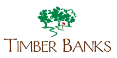 Timber Banks logo: Green trees with a red flag over a winding path; brown text "Timber Banks".