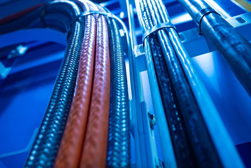 Bunch Of Wires Are Connected To Each Other In A Blue Room — Mingleford Electrical Airconditioning Solar & Gas In Kenilworth, QLD