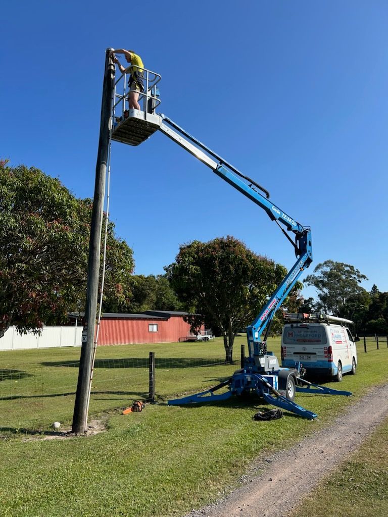 Electrician Fixes The Electric Cable — Mingleford Electrical Airconditioning Solar & Gas In Landsborough, QLD