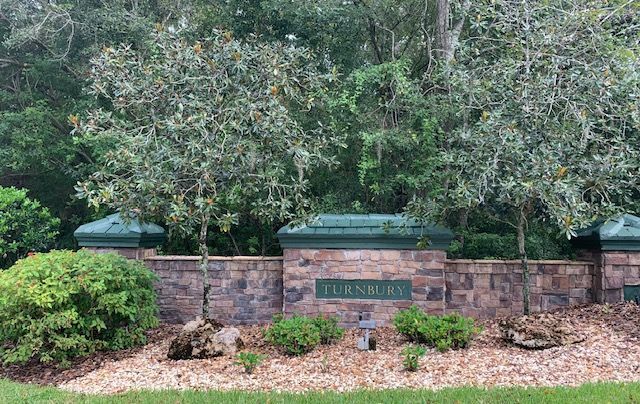 A stone wall with a sign that says turnbury on it