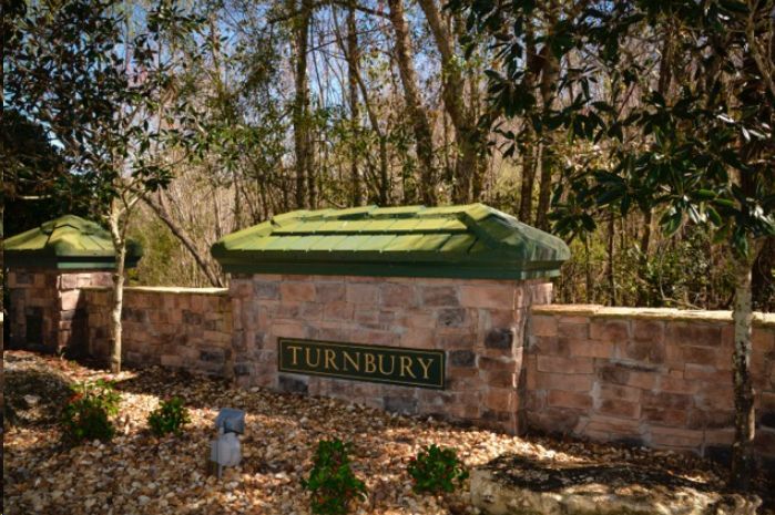 A stone wall with a sign that says turnbury on it