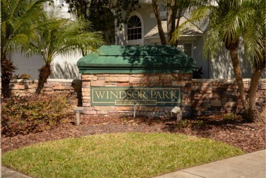 A sign for windsor park is in front of a house