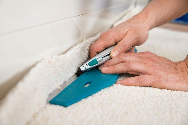 Worker Installing New Carpet Worker Installing New Carpet