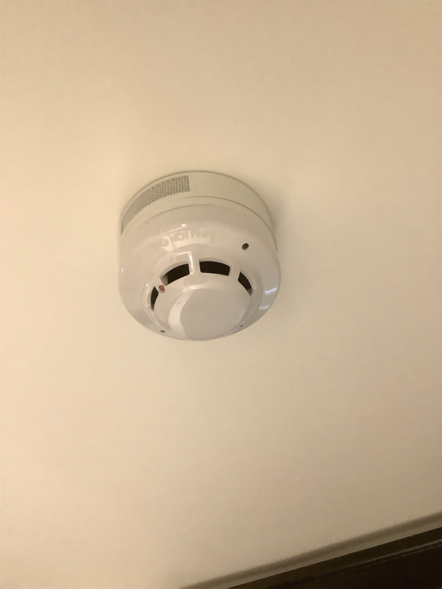 Hardwired smoke alarm fitted to ceiling – safety compliance documented