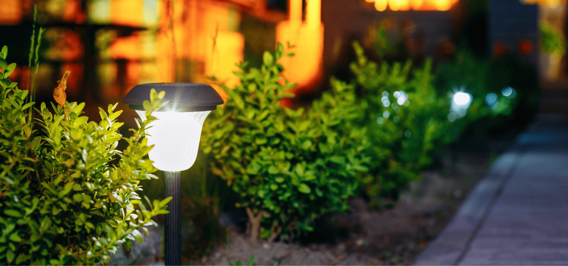 Solar bollard lights along a path in a garden in Louisville
