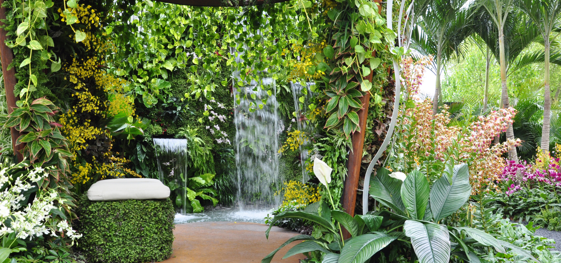 Grand waterfall in a tropical garden in a public space landscaped by Louisville Landscape Pros
