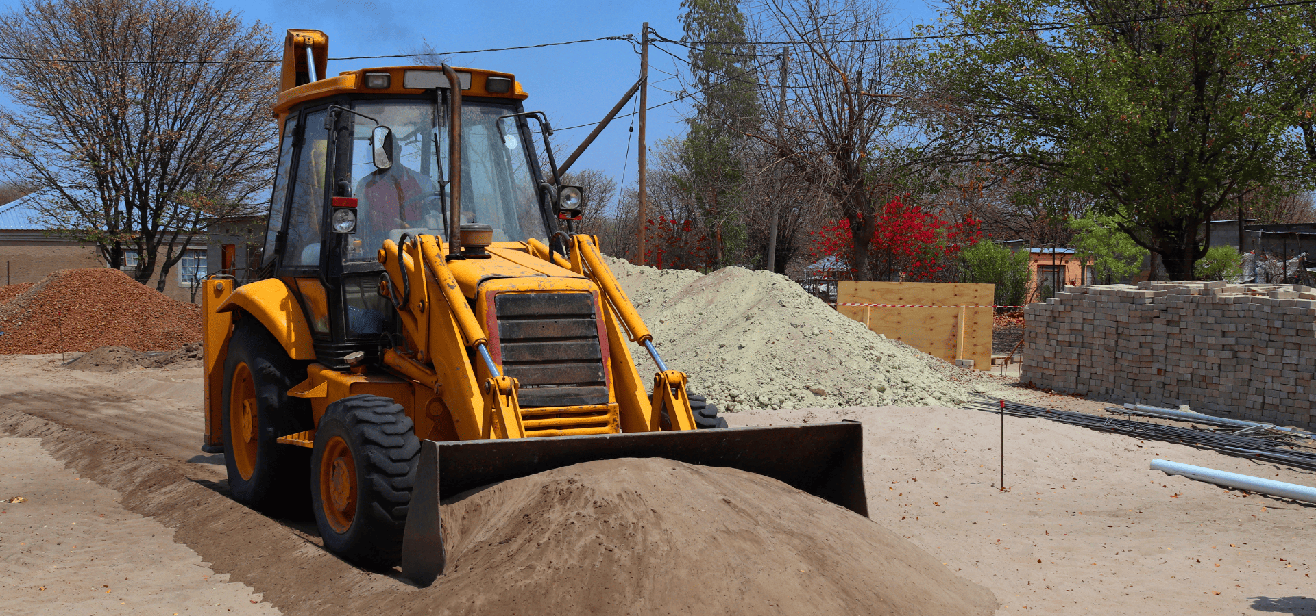 Loader at commercial project site moving sand