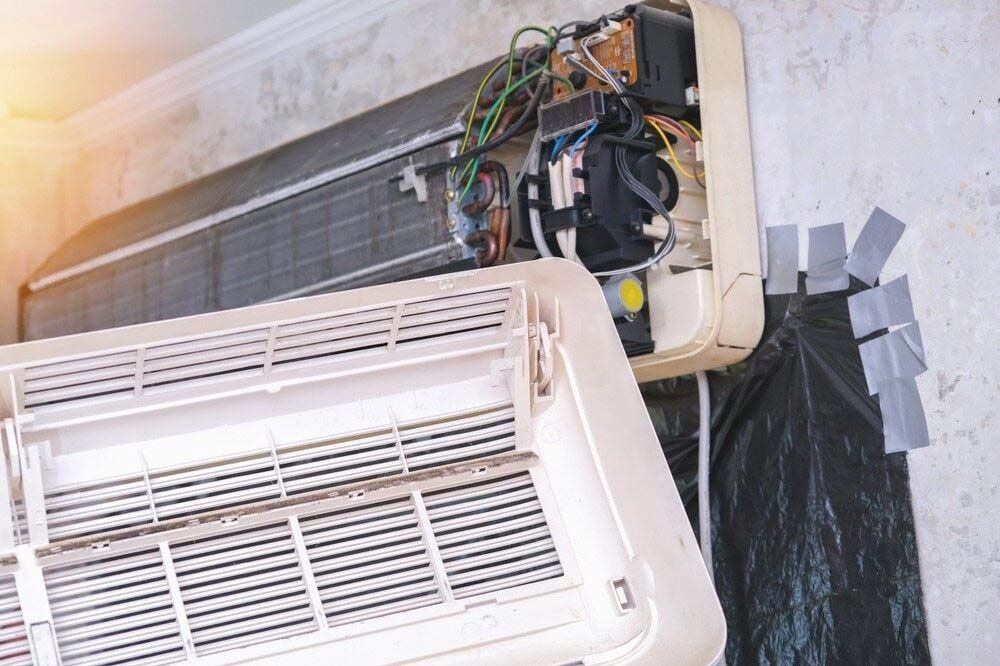 The Inside Of An Air Conditioner Is Being Repaired — Jordan Wheatland Air Conditioning & Refrigeration In Dubbo, NSW