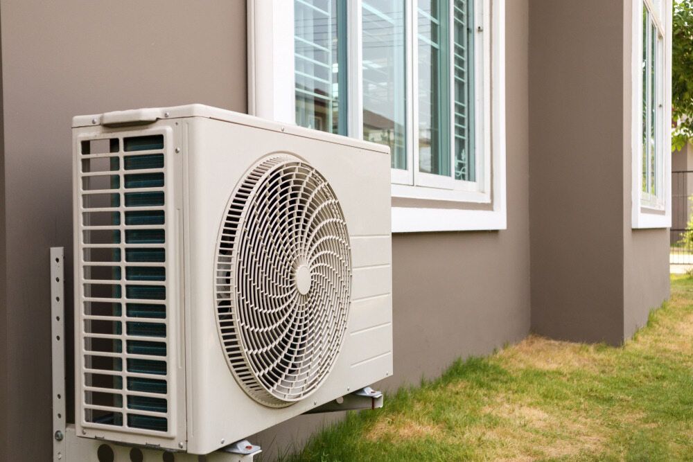 A Man Is Measuring A Fan With A Tape Measure — Jordan Wheatland Air Conditioning & Refrigeration In Dubbo, NSW