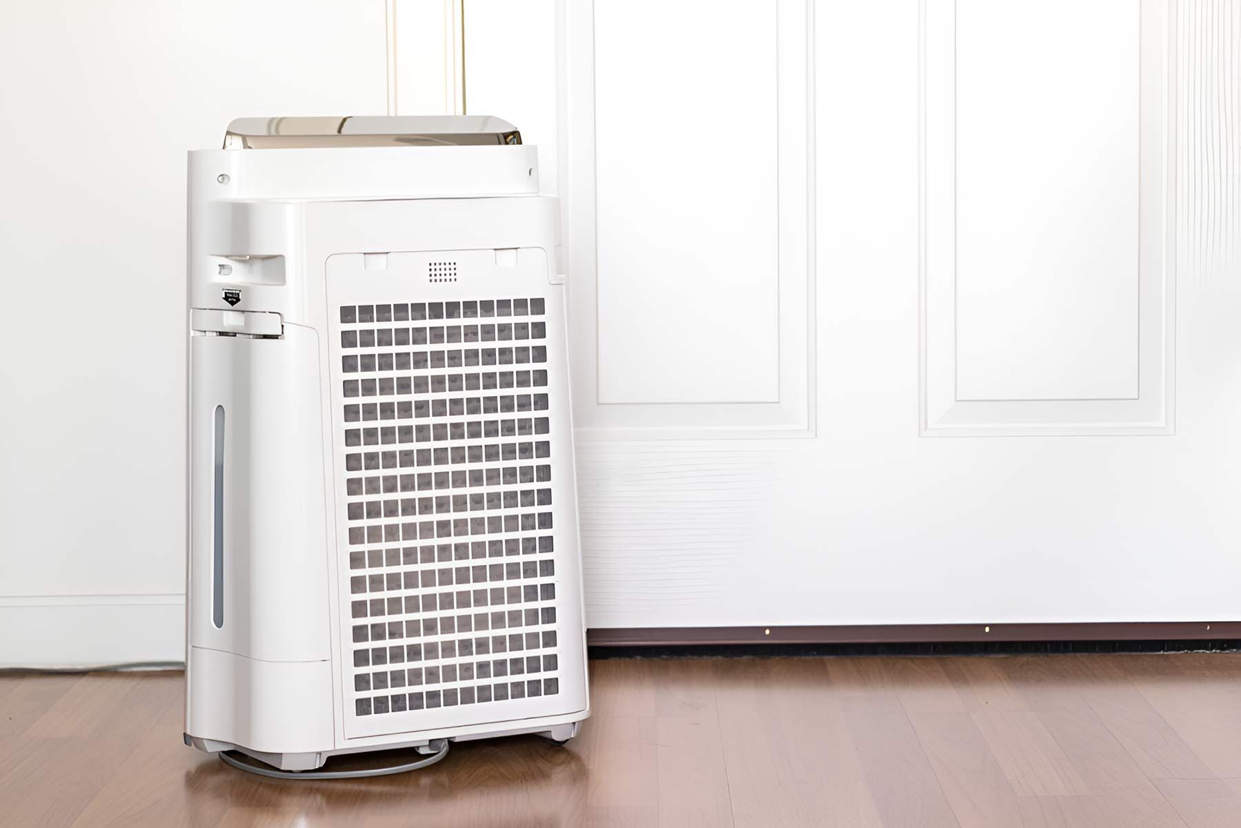 A White Air Purifier Is Sitting On A Wooden Floor — Jordan Wheatland Air Conditioning & Refrigeration In Coonamble, NSW