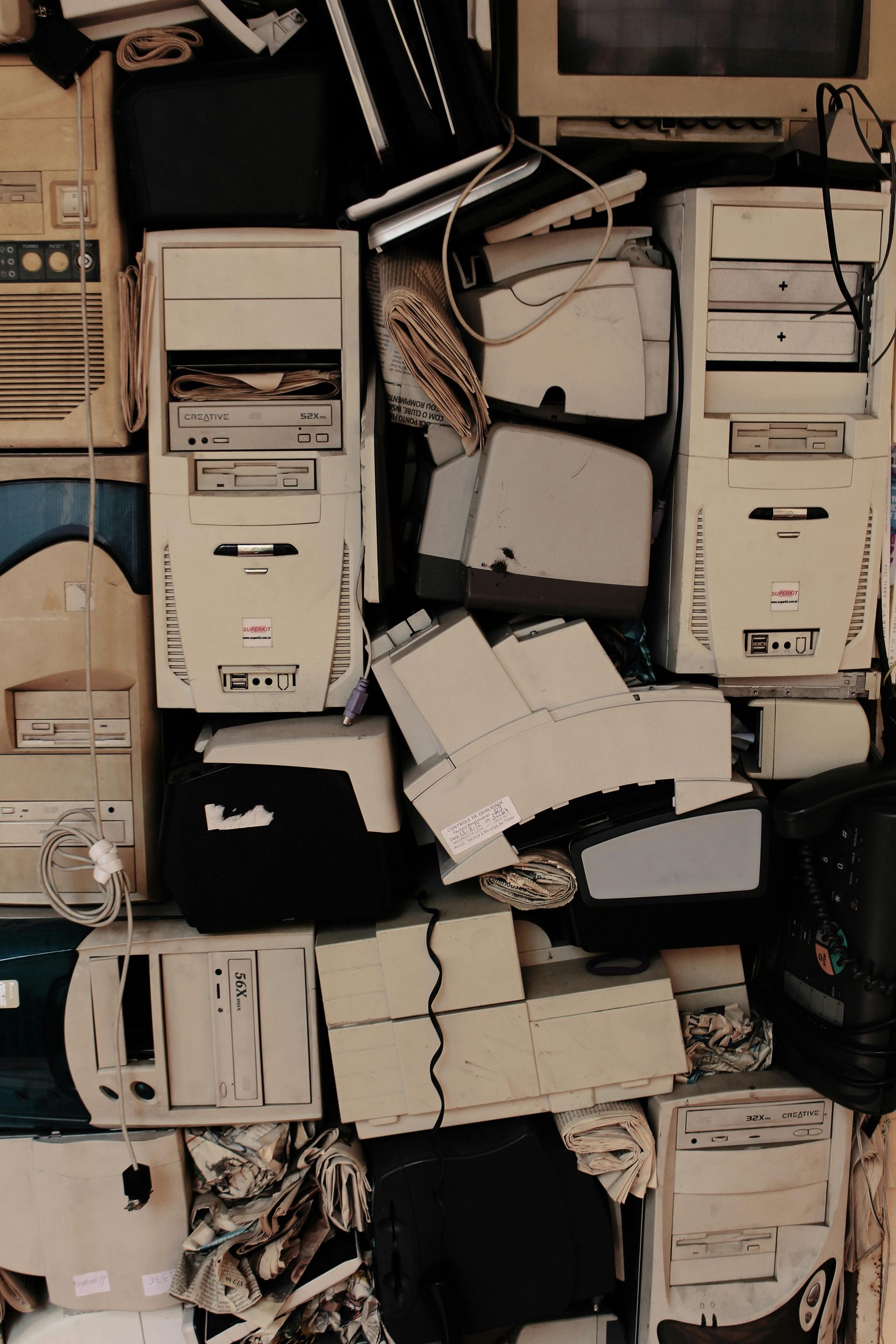 Pile of beige and white obsolete computers and equipment, wires tangled in Boulder, CO.