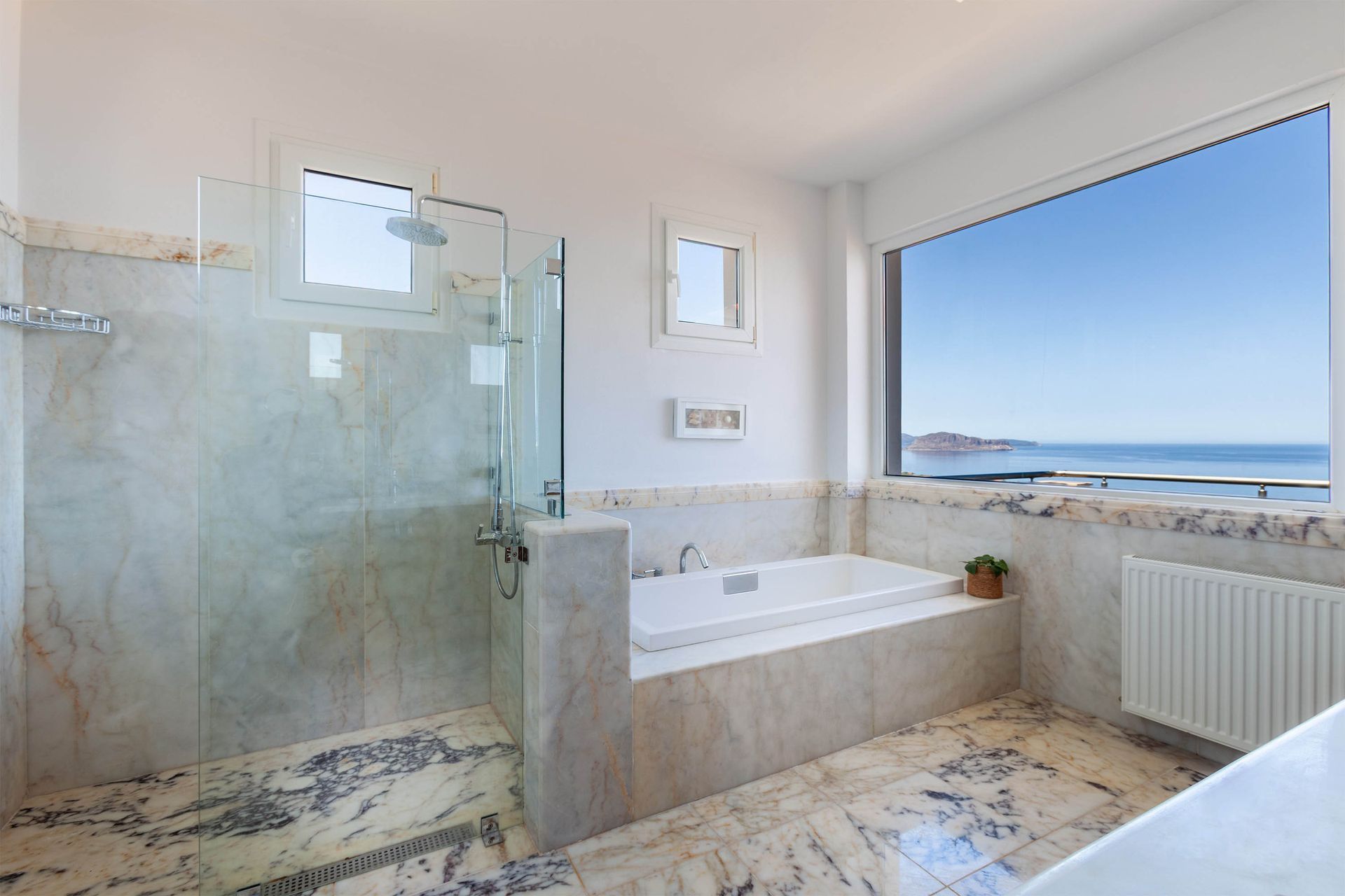 Marble bathroom and bath framing a coastal sea view