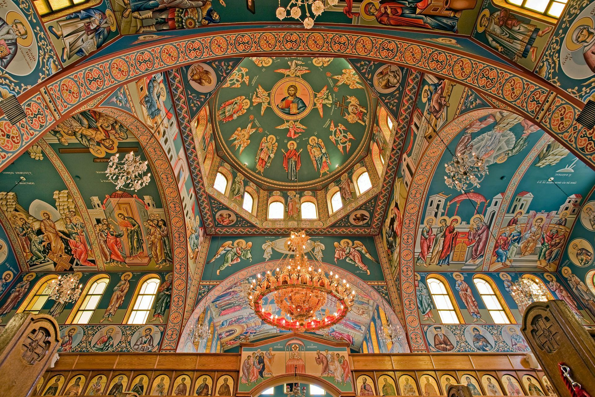 Teal and gold painted church ceiling with chandeliers
