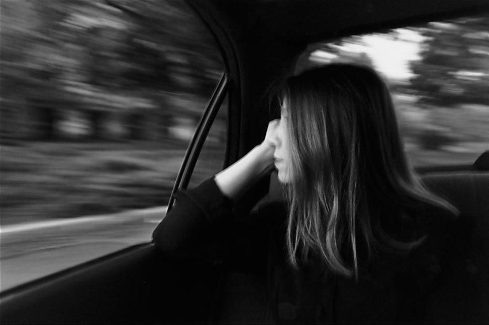 Passenger viewed from the back seat of a car