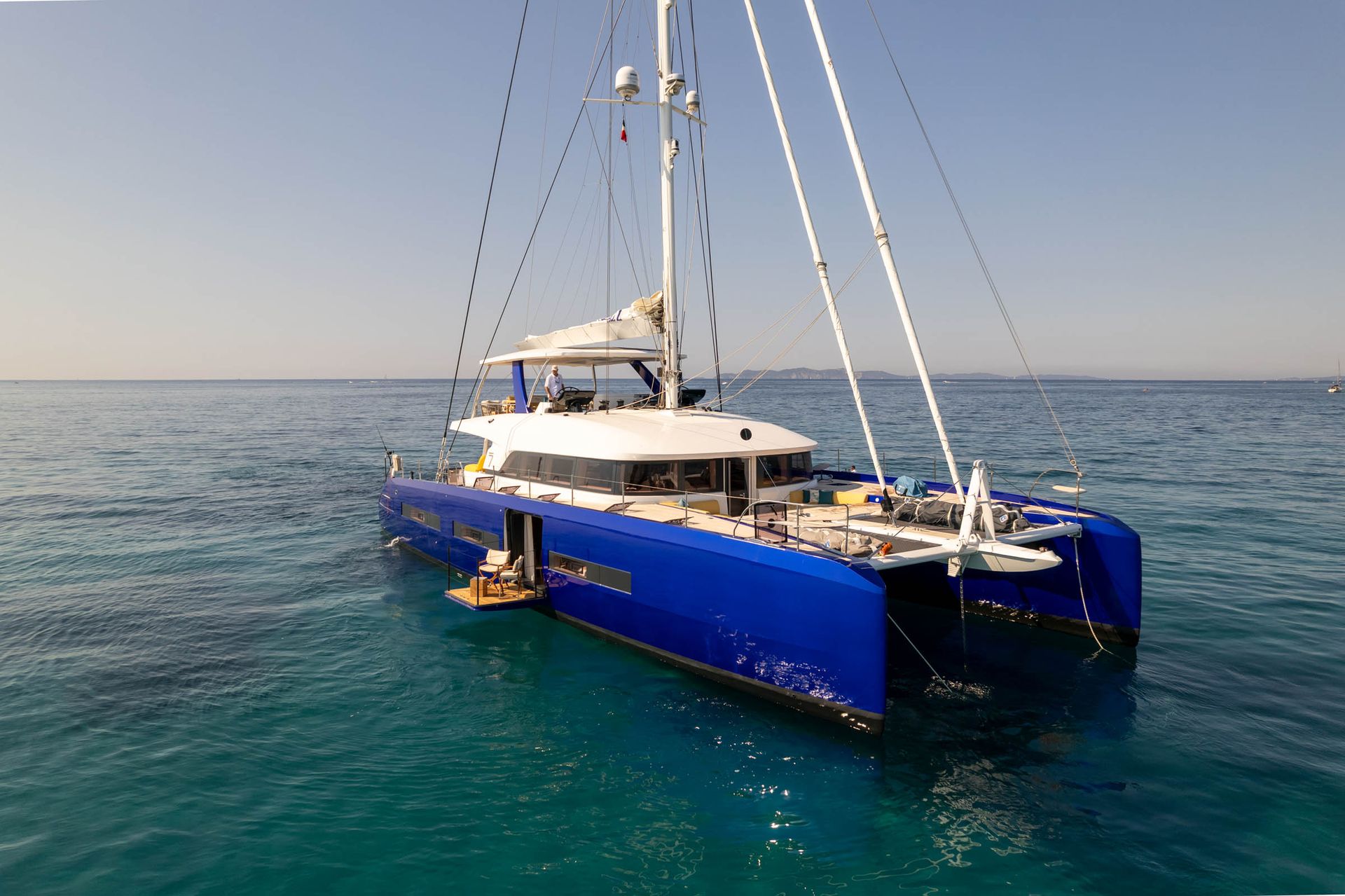 Blue catamaran at anchor viewed from above