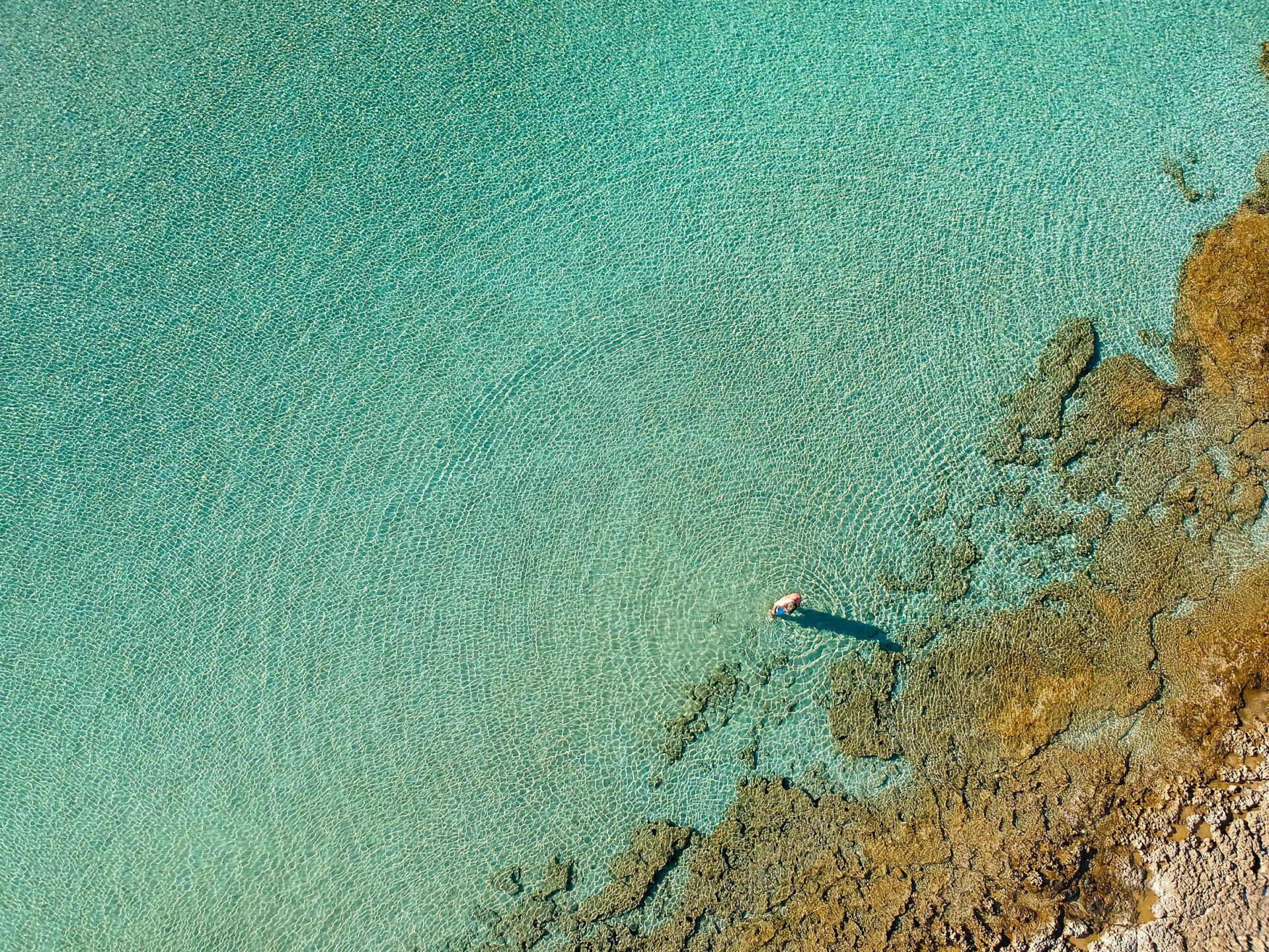 Swimmer making circles in the sea in the Peloponnese, Greece