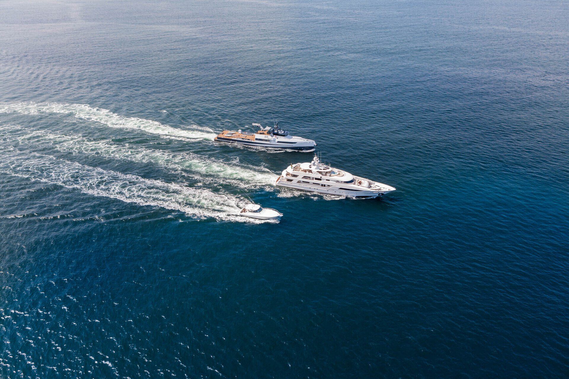 Aerial view of motor yacht Gigi underway with accompanying vessels