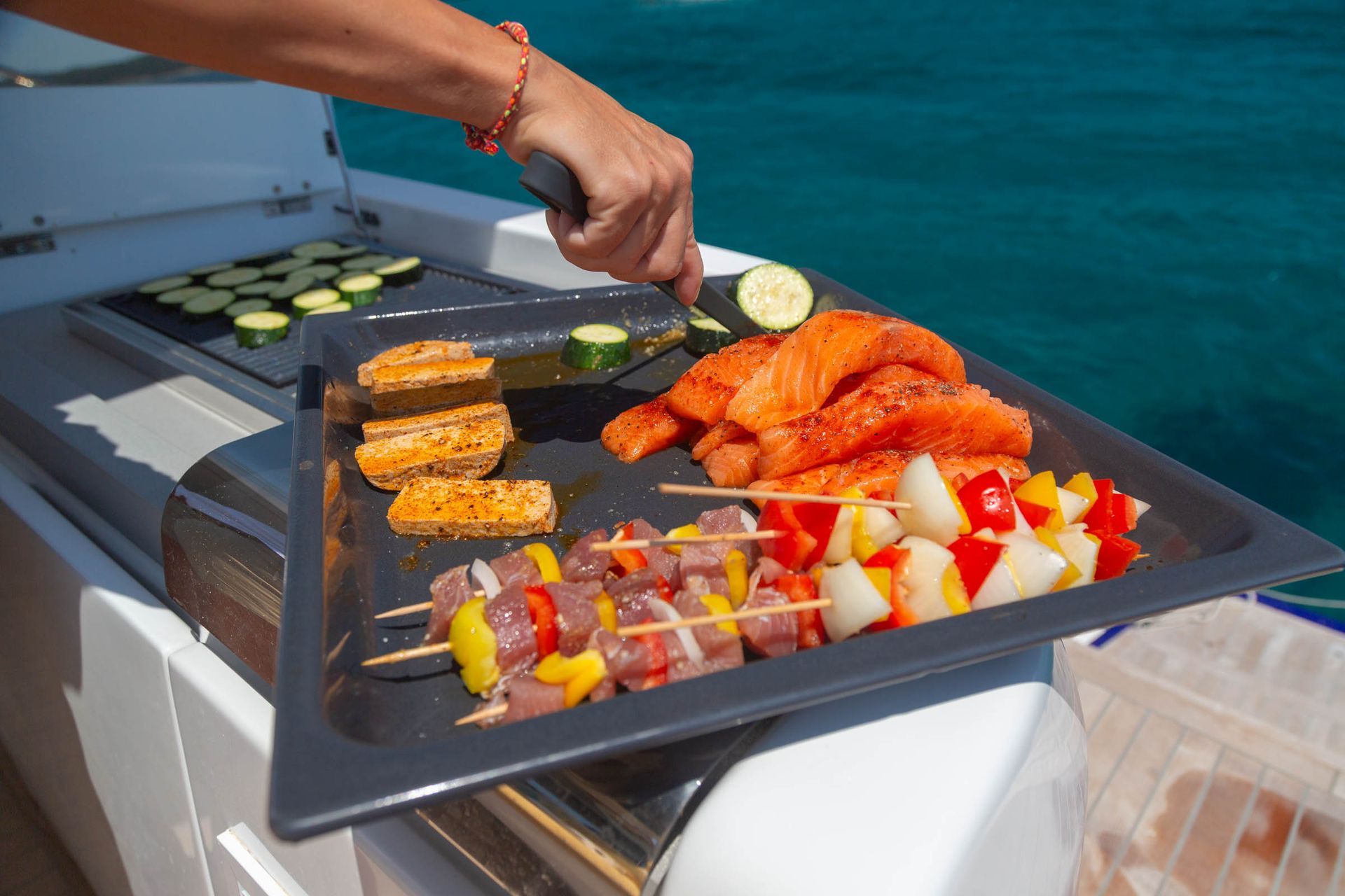 Fresh seafood and vegetables being prepared at the exterior grill