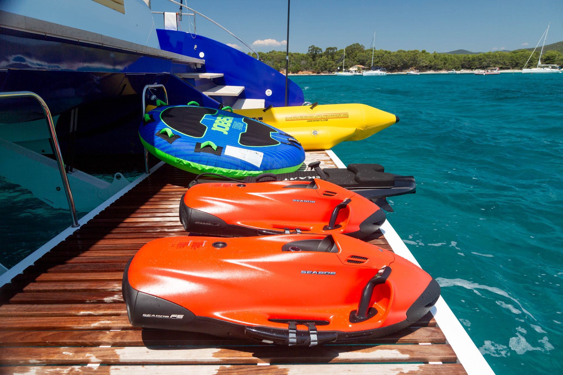 Colourful water toys prepared on the catamaran's stern platform