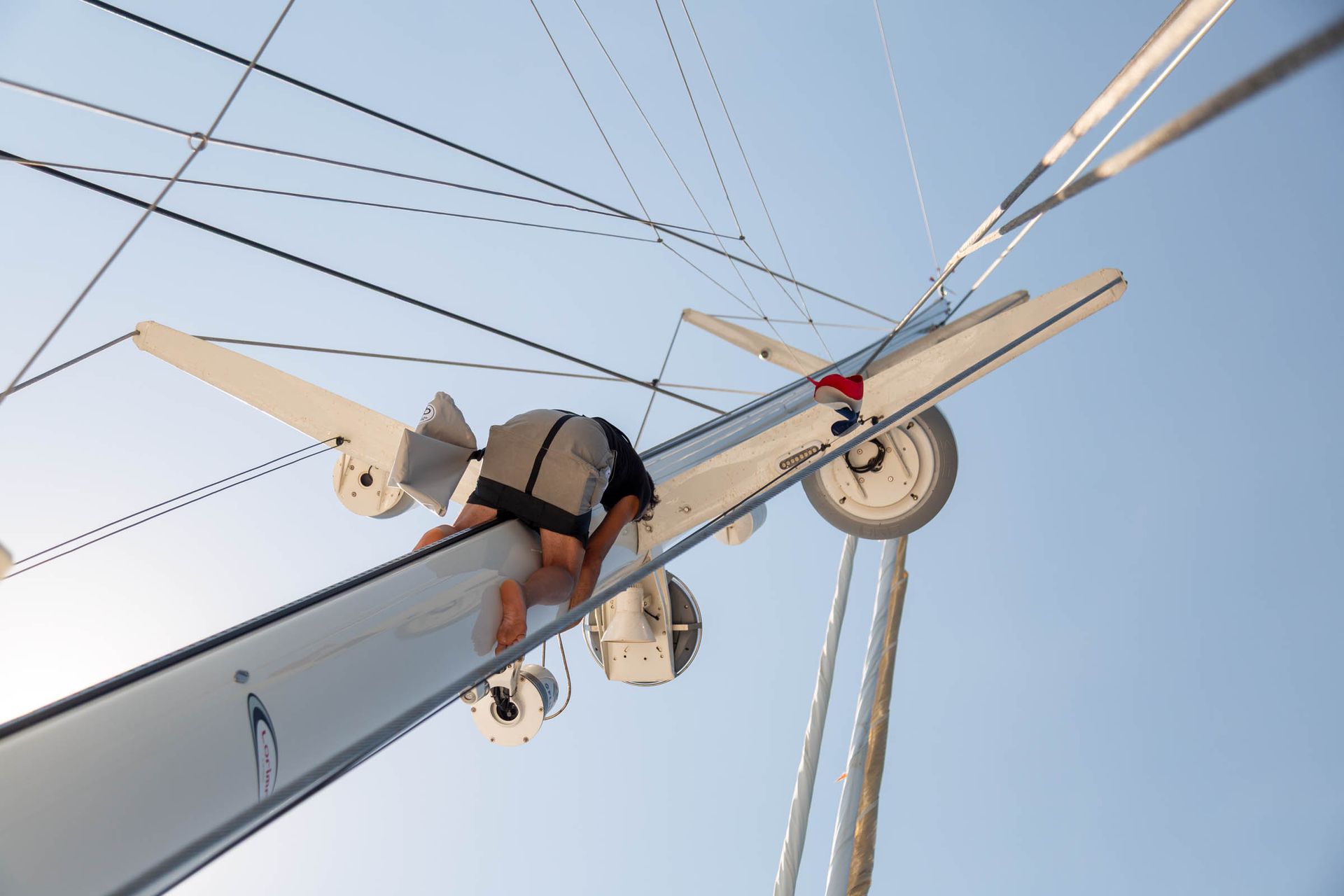 Crew member working aloft among the rigging