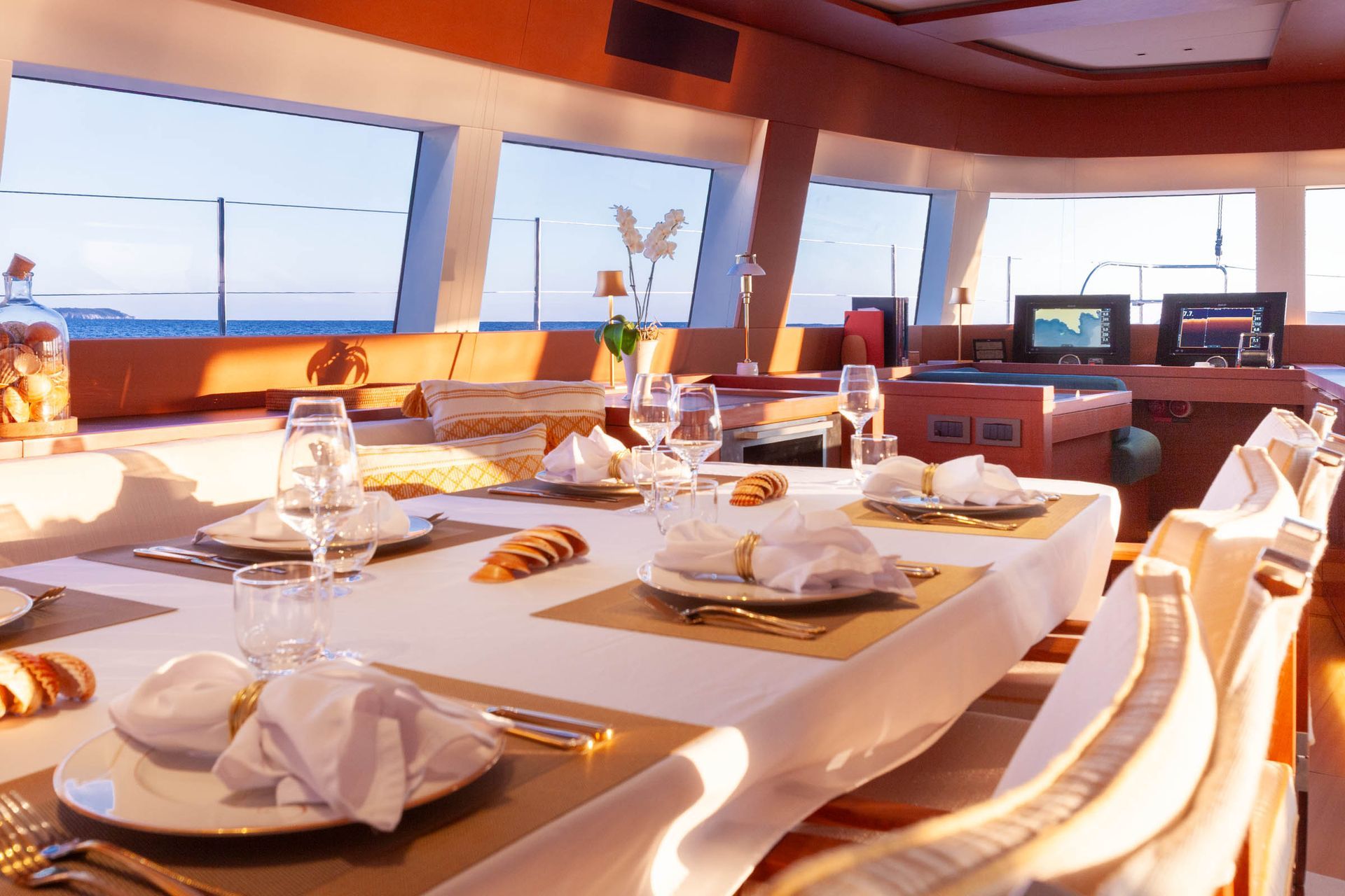 Formal dining table prepared inside the catamaran salon