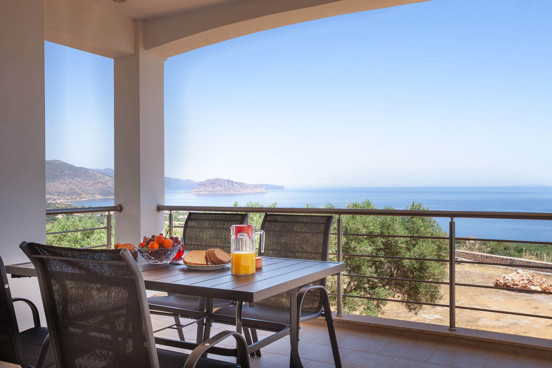 Breakfast table on a terrace overlooking the sea