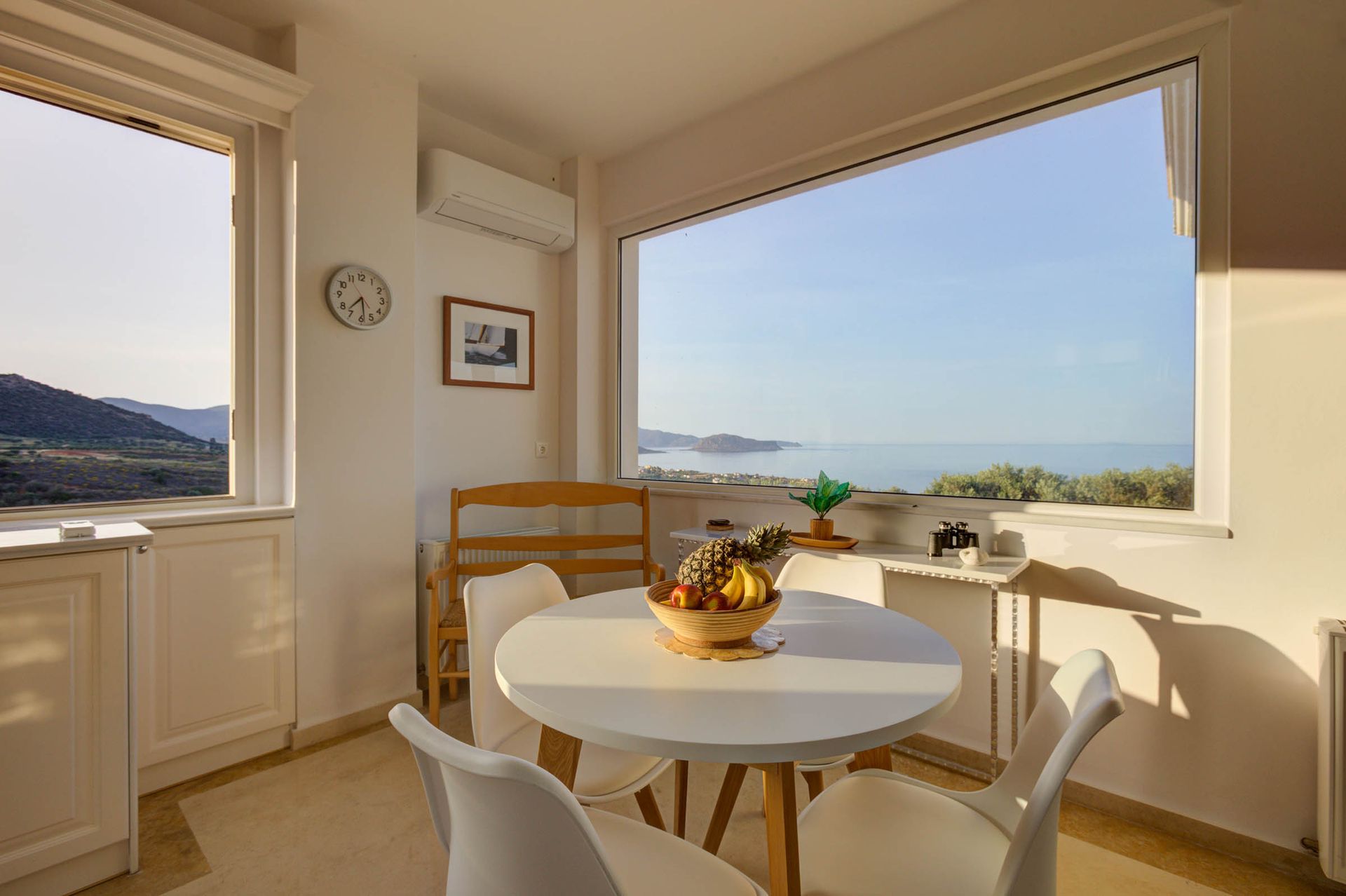 Sunlit dining area with panoramic sea views