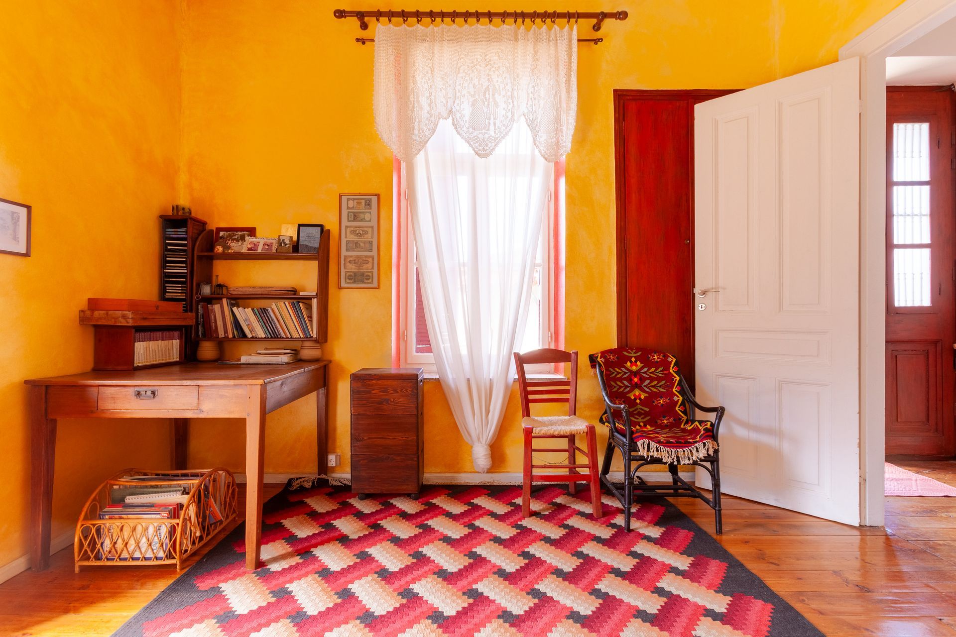 Heritage guest room with yellow walls, patterned textiles and a writing desk