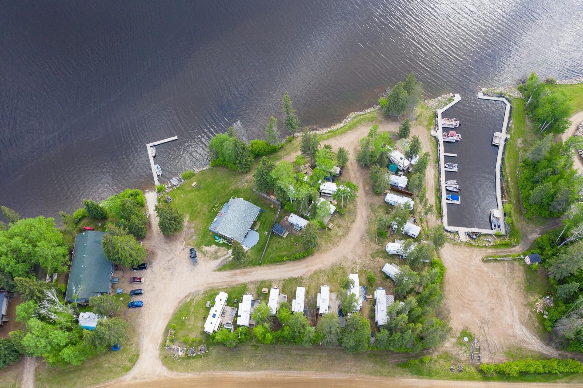 An aerial view of a campground on the shore of a lake.