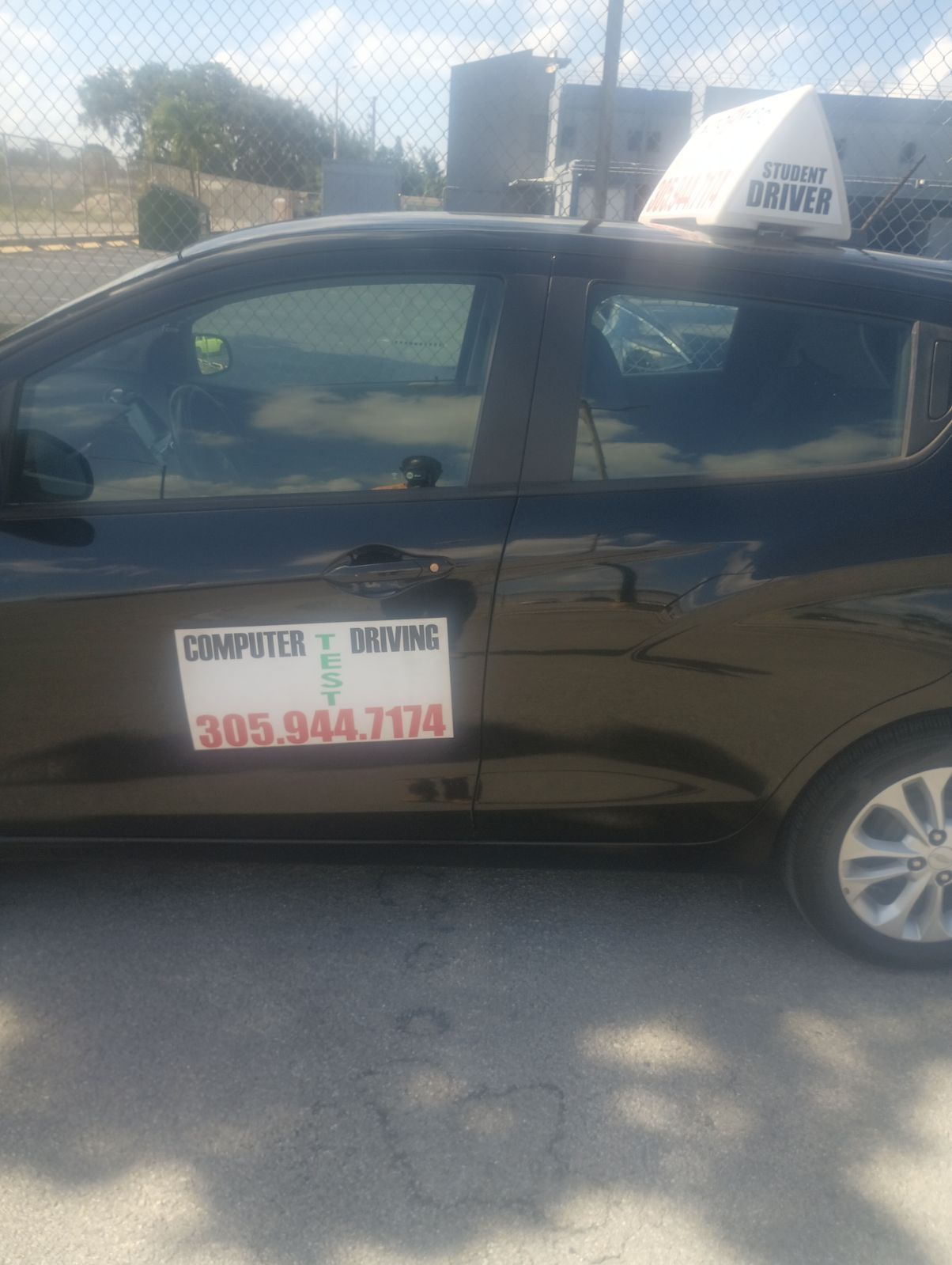 A black car with a sticker on the side that says computer driving
