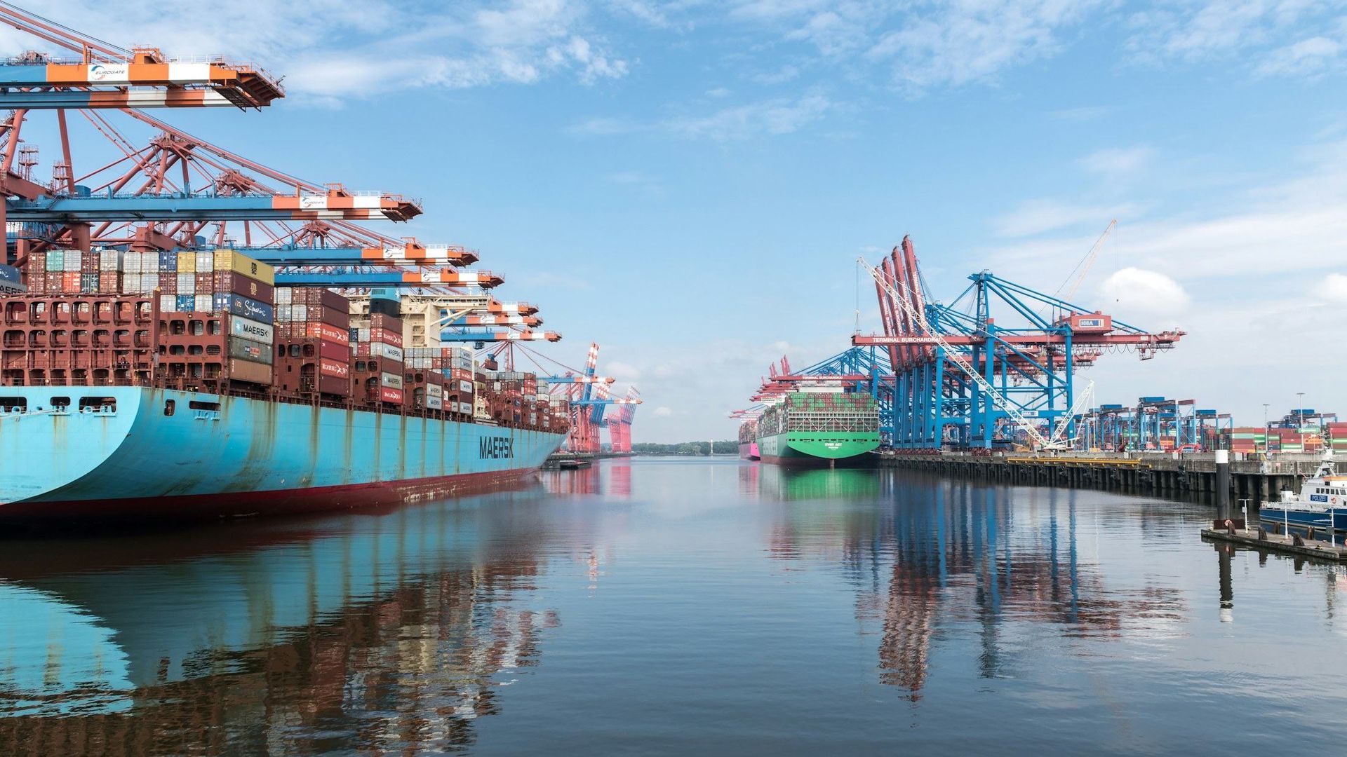 Container ships and cranes at a busy international port