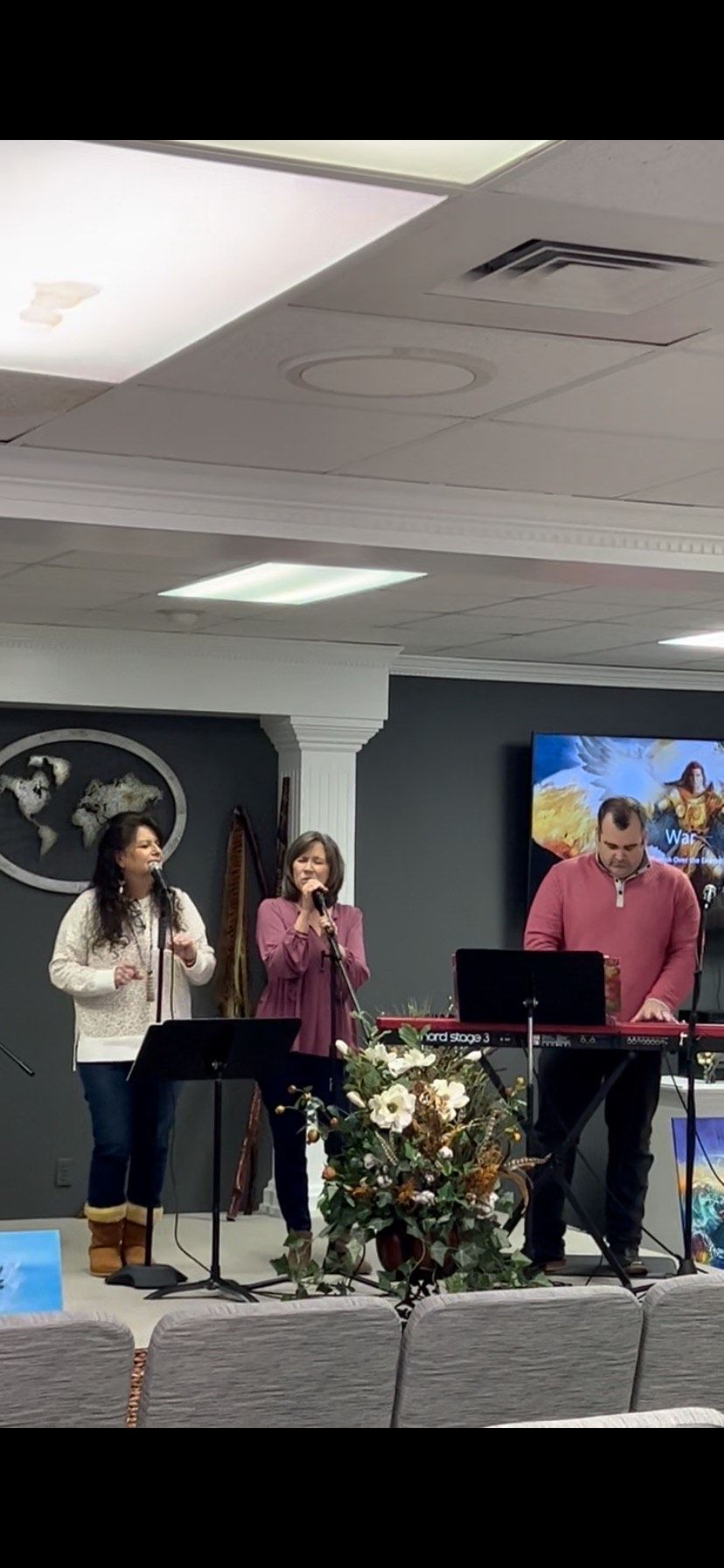A group of people are singing and playing instruments in a church.