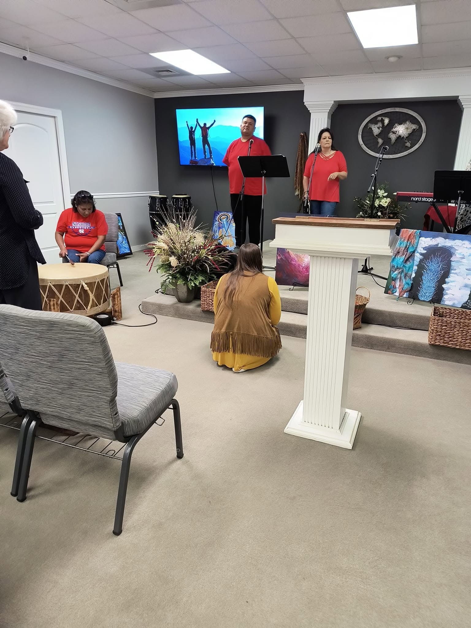 A group of people are sitting around a podium in a room