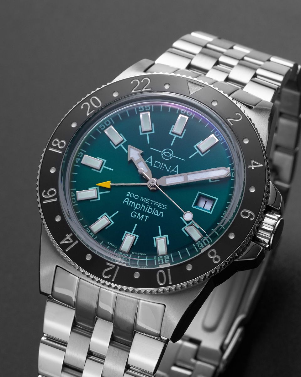 A teal-faced Adina Amphibian GMT watch with a black 24-hour rotating bezel and a stainless steel link bracelet. — Coastal Clocks & Watches in Buddina, QLD