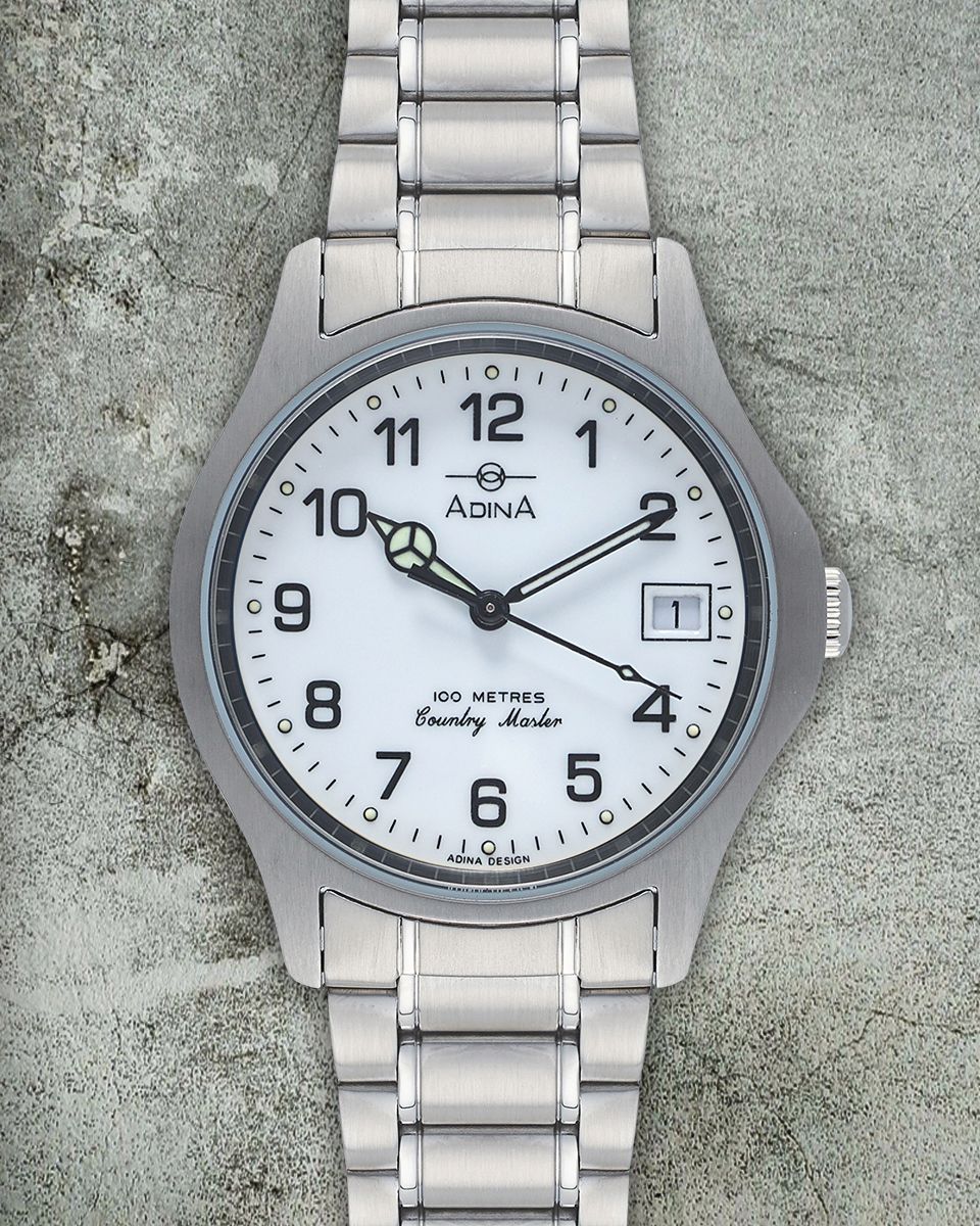 A silver Aevig Corvid watch with a white dial, black Arabic numerals, and a metallic link band on a textured background. — Coastal Clocks & Watches in Buddina, QLD