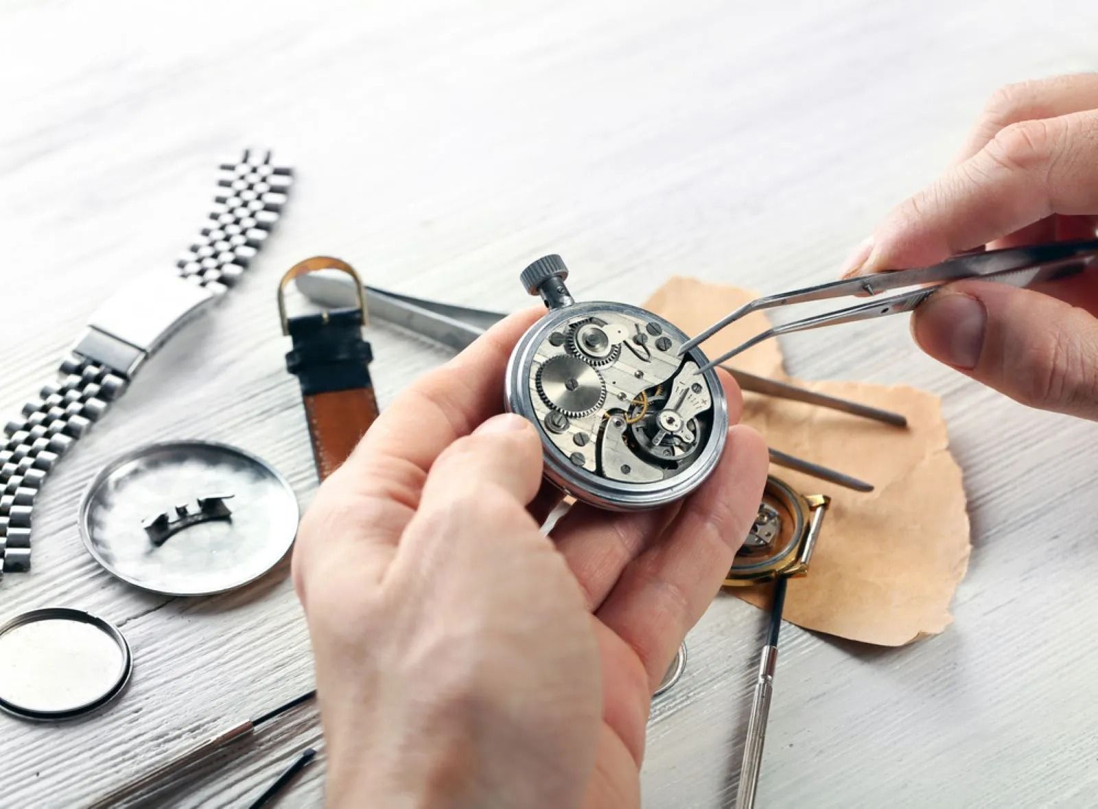 Hands Using Tweezers to Work on a Pocket Watch's Intricate Mechanism — Coastal Clocks & Watches in Buddina, QLD