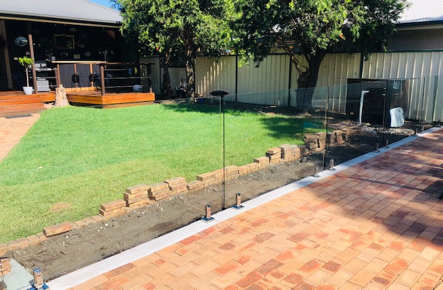 A Backyard With Brick Pattern Patio with Glass Railing — Long Jetty Glass in The Entrance, NSW