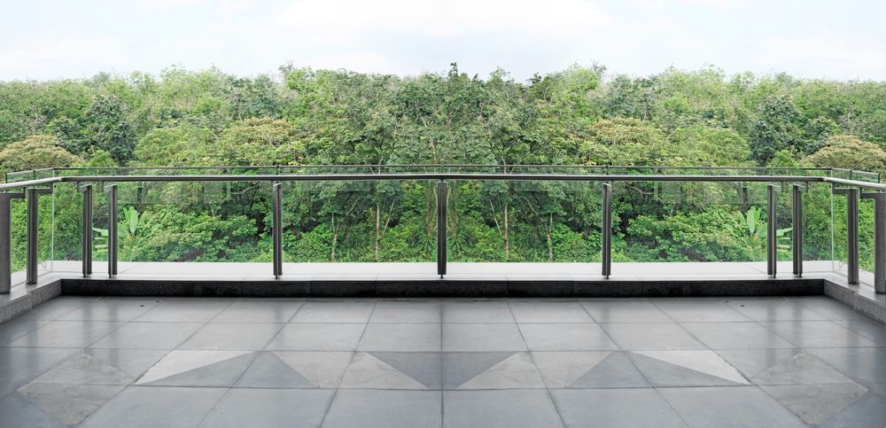 A Balcony With Glass Railing Overlooks a Dense Green Forest — Long Jetty Glass in The Entrance, NSW