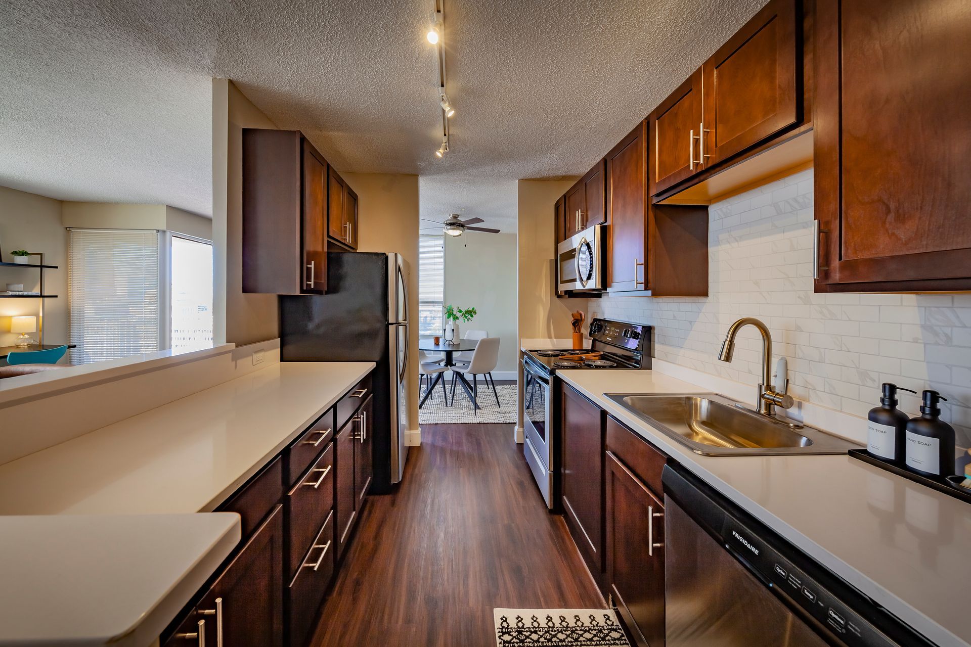 A kitchen with stainless steel appliances and wooden cabinets at  Riley Towers, Indianapolis, IN. 
