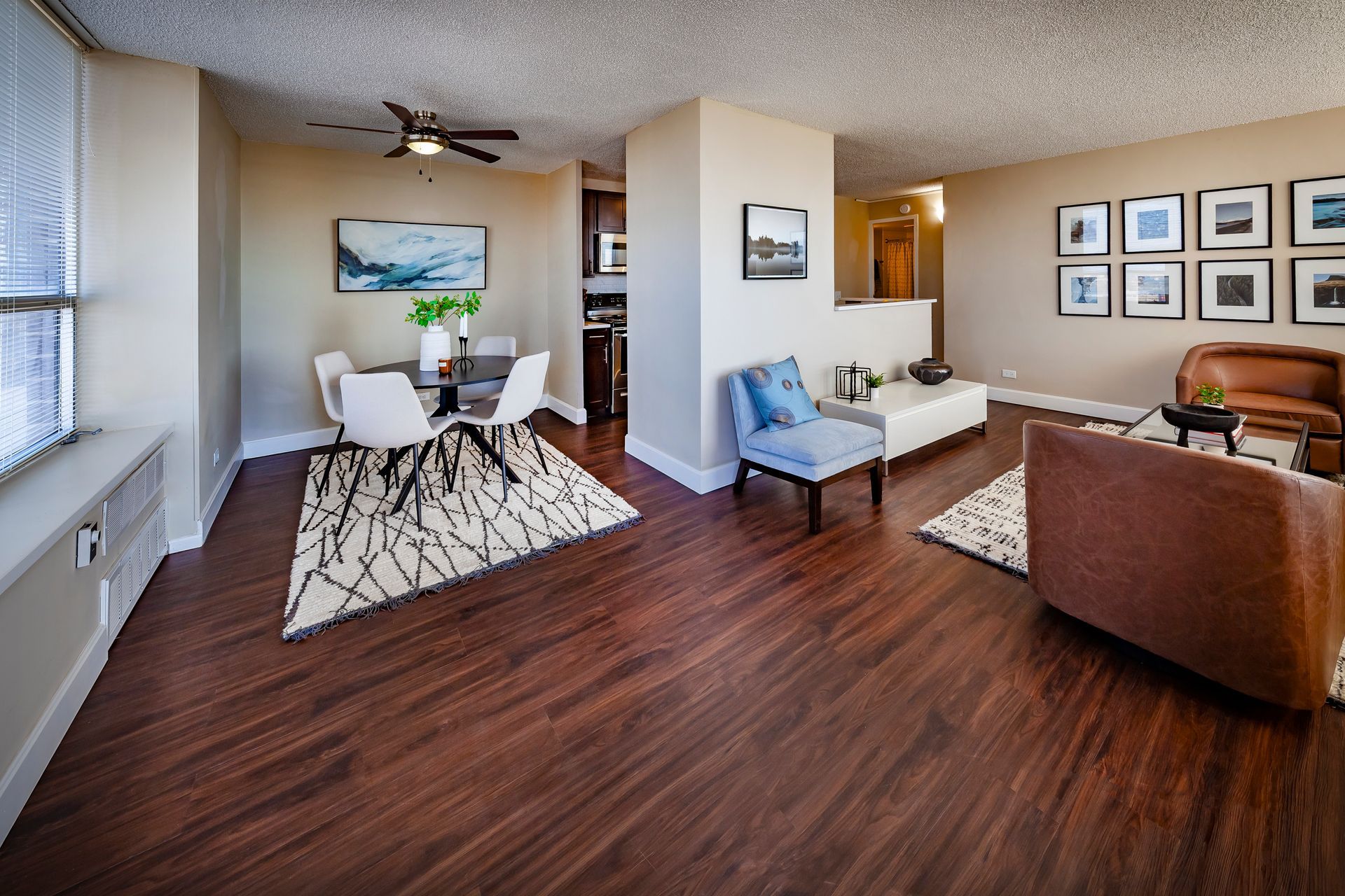 A living room with hardwood floors and a ceiling fan at  Riley Towers, Indianapolis, IN. 