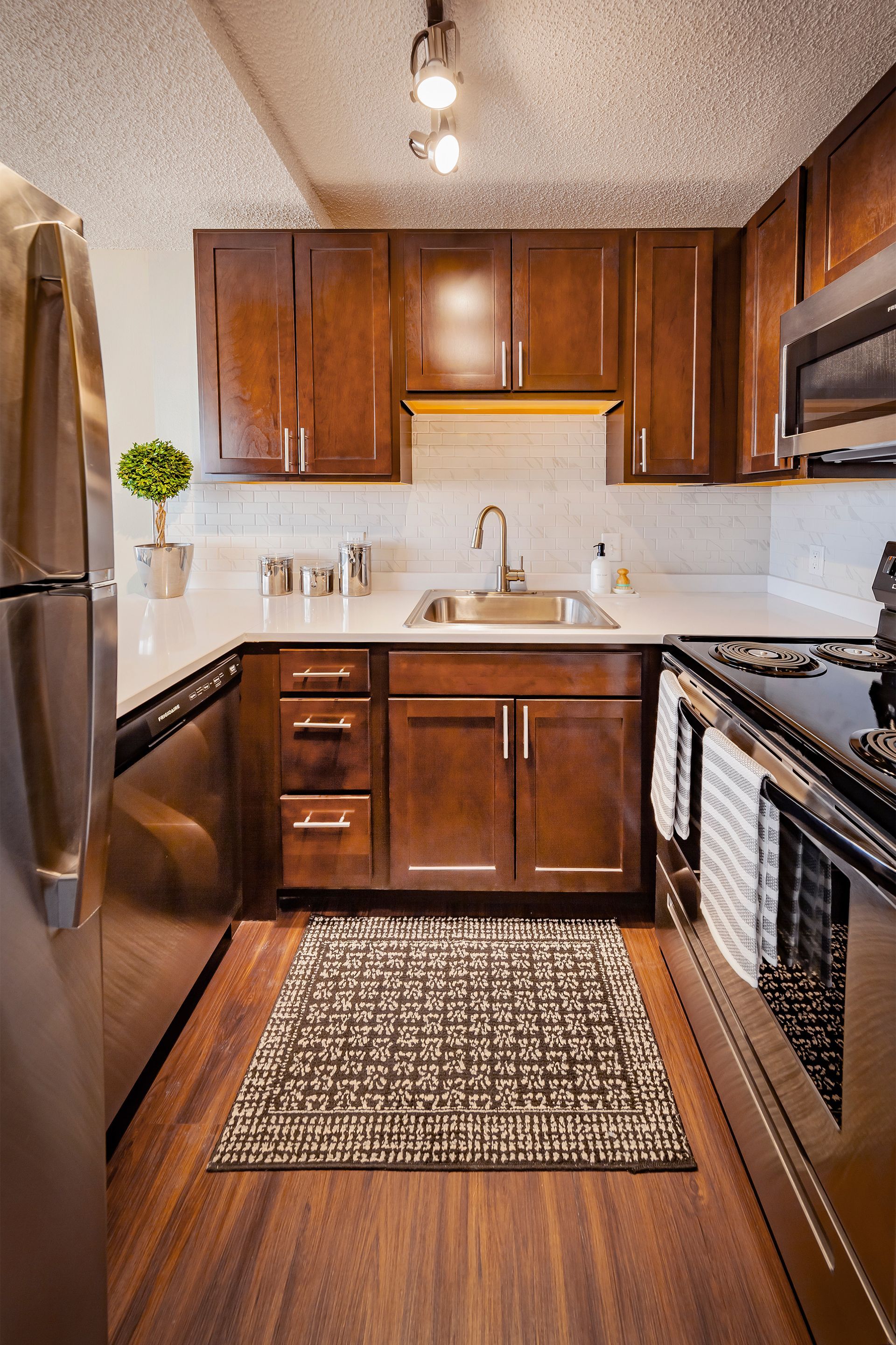 A kitchen with stainless steel appliances and wooden cabinetsmat  Riley Towers, Indianapolis, IN. 