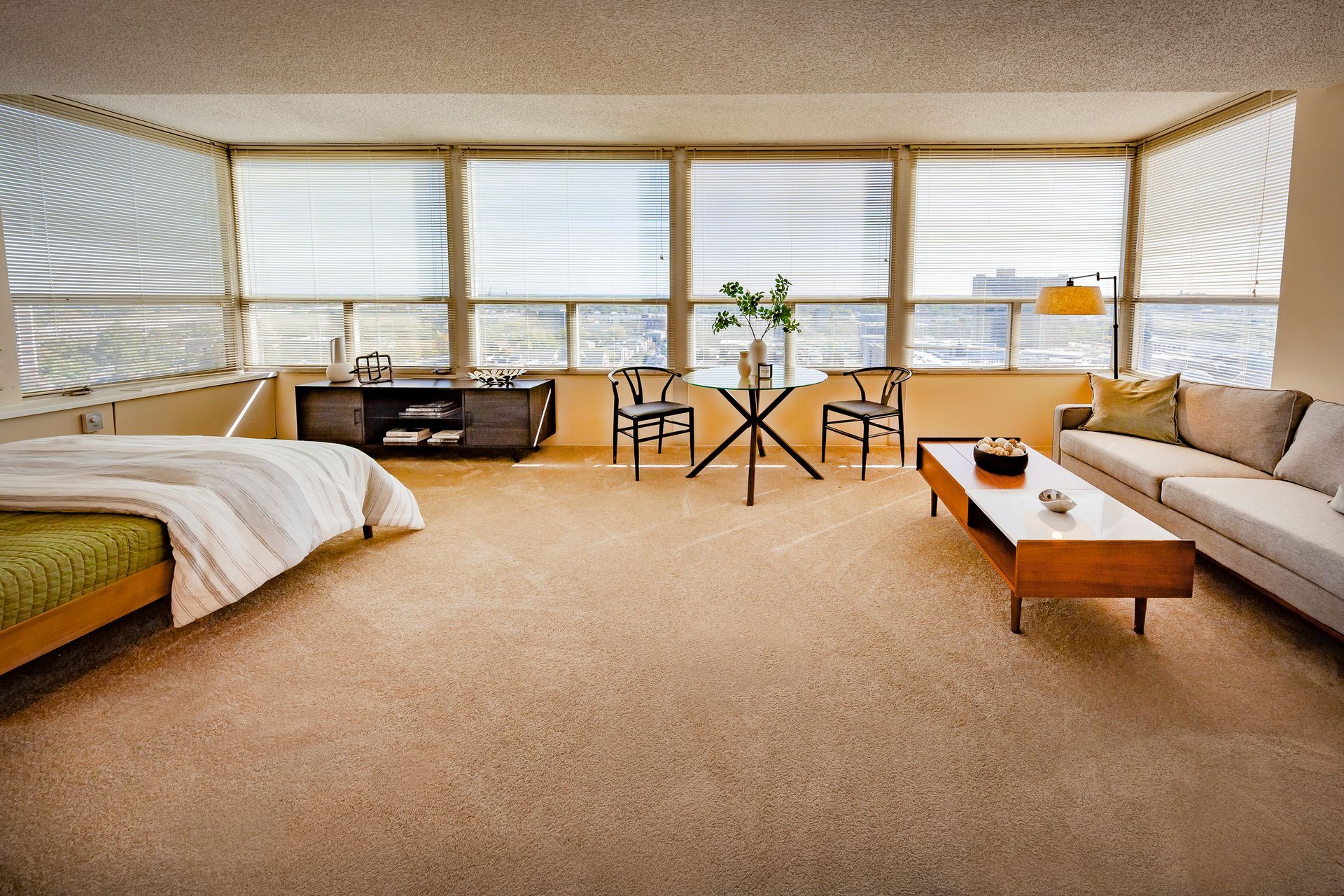 A bedroom with a couch and a table in it at  Riley Towers, Indianapolis, IN. 