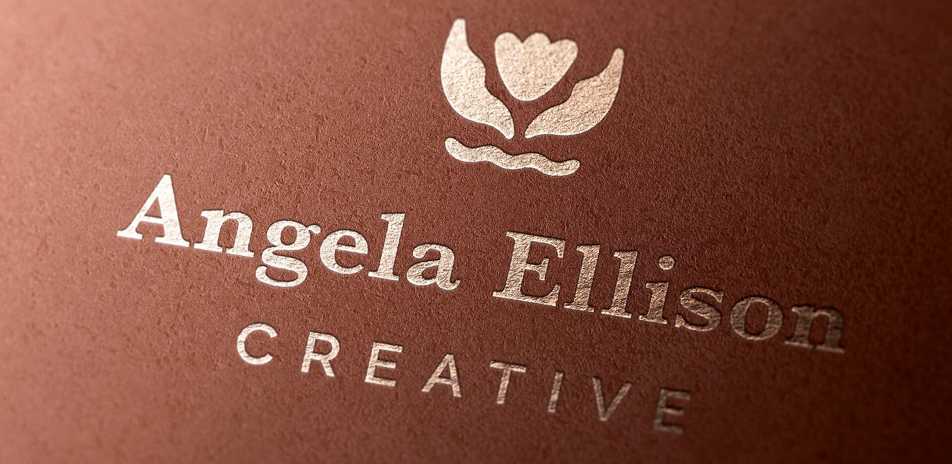 New primary logo foil stamped on copper-colored textured paper for sustainable small business.