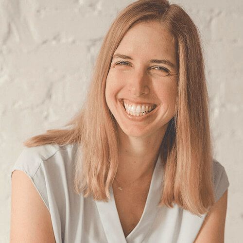 Sustainable small business owner smiling.