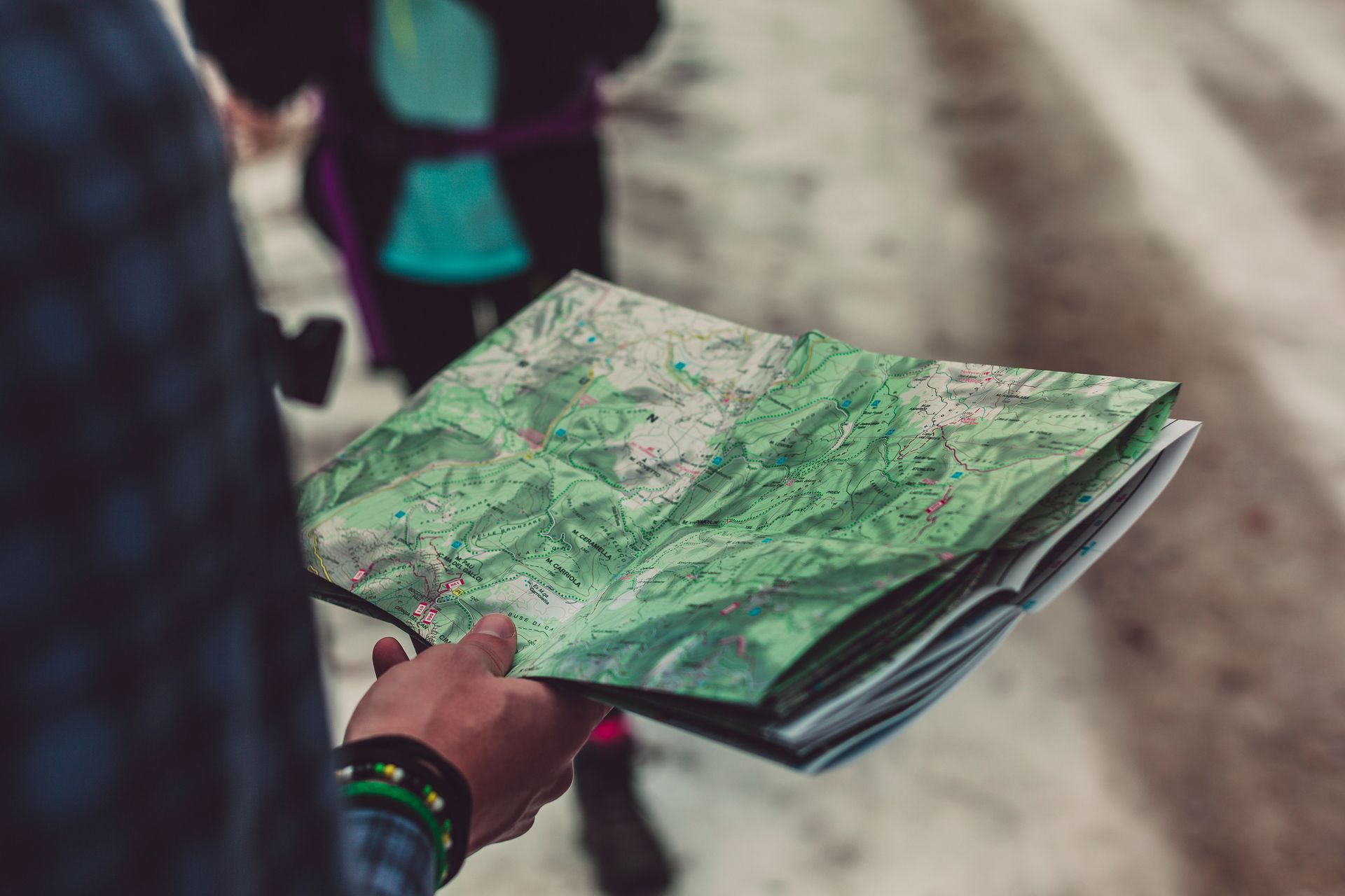 Hiking guide looking at a map to find the best route forward.