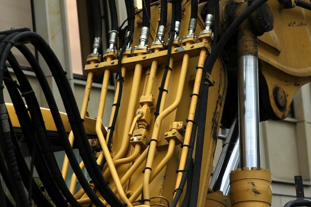 A Bunch of Hydraulic Hoses Are Connected to A Machine — Cheshire Machinery in Svensson Heights, QLD