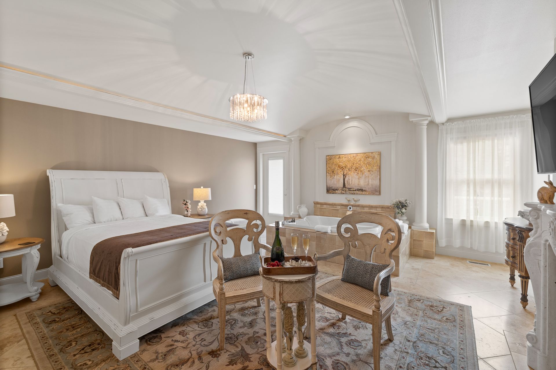 A bedroom with a bed , desk , chair and fireplace.