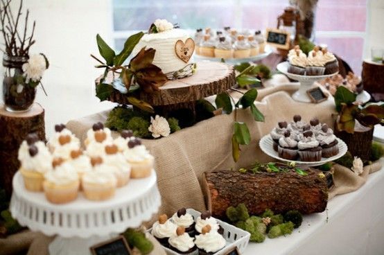 A table topped with cupcakes and a cake.