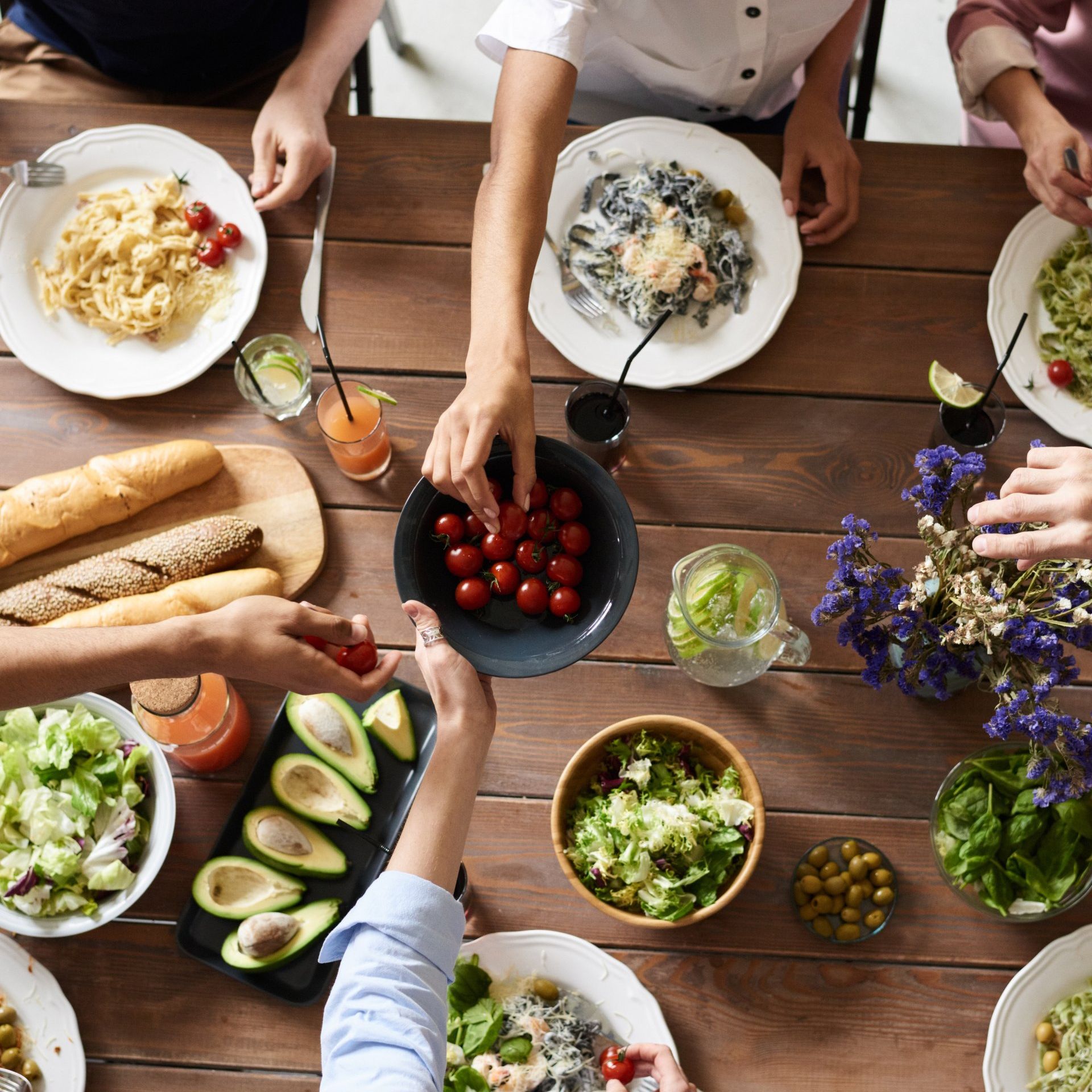 A group of people are sitting at a table with plates of food.