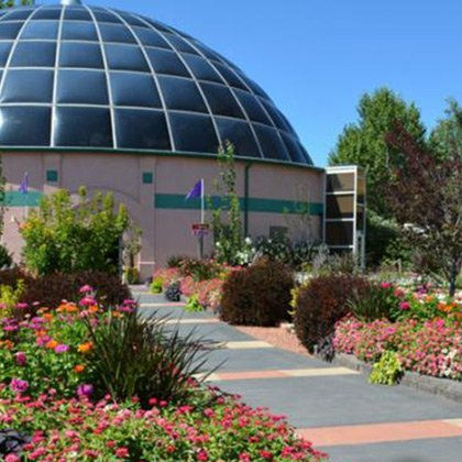A dome shaped building with flowers in front of it